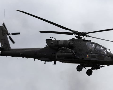 US Army AH-64 Apache helicopter patrolling near the Strait of Hormuz during Iran war operations 2026