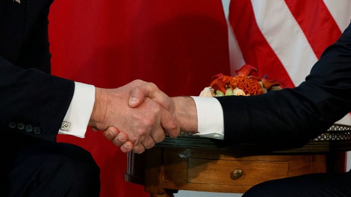 Trump shakes hands with Macron during a meeting at the U.S. Embassy in Brussels, May 2017