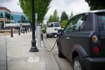 A UK electric vehicle charging station as battery EV annual sales outpace petrol for the first time