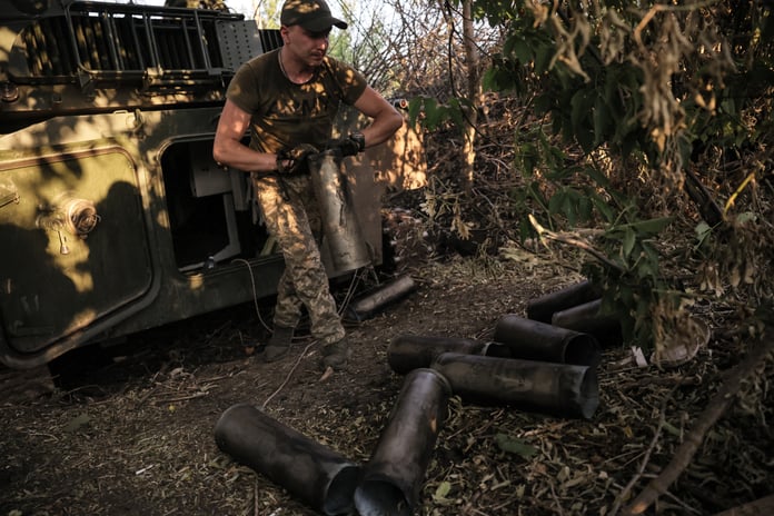 Ukrainian soldier operating a 122mm self-propelled howitzer at the frontline in Donetsk region during the Russian operation in Ukraine