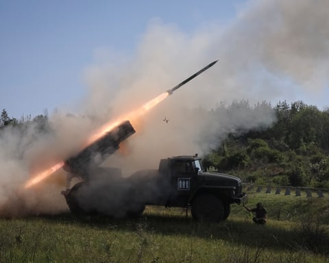 Ukrainian soldiers fire a BM-21 Grad rocket launcher toward Russian positions in Donetsk region, June 2025