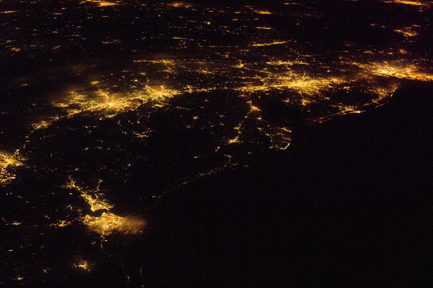 NASA astronaut photograph from the International Space Station of the United States Atlantic Seaboard at night with Boston, New York, Philadelphia, Baltimore, and Washington DC visible as connected bright urban regions