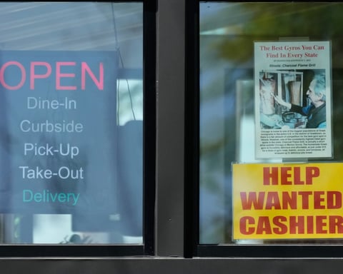 A hiring sign displayed at a restaurant in Morton Grove Illinois as US weekly jobless claims hit 225000 highest since February 2026