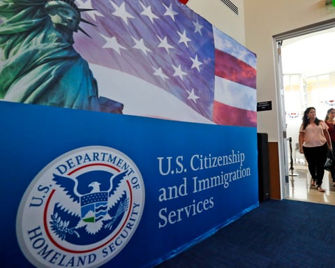 People arrive for a naturalization ceremony at a US Citizenship and Immigration Services office in Miami