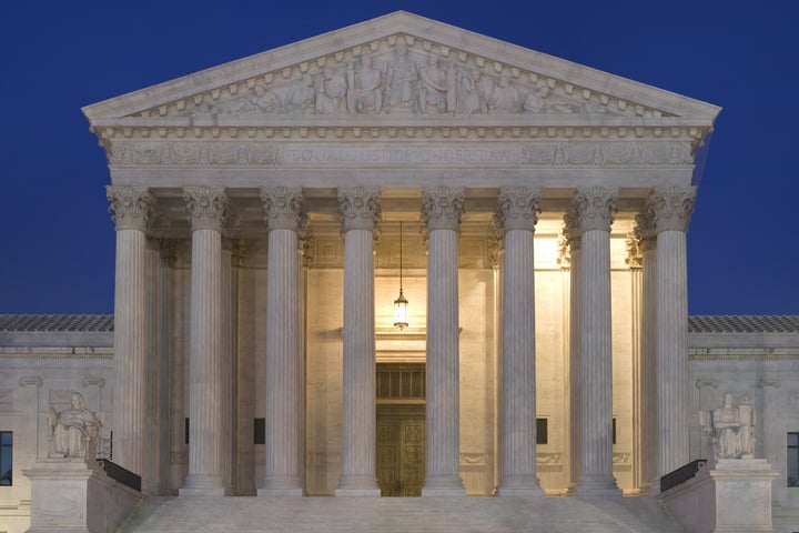 The United States Supreme Court building in Washington DC at dusk