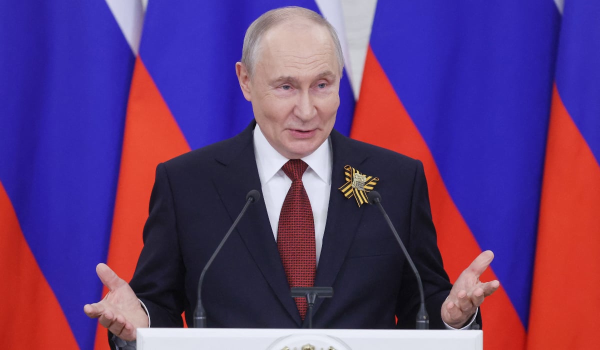 Russian President Vladimir Putin talks to the media at the Kremlin in Moscow