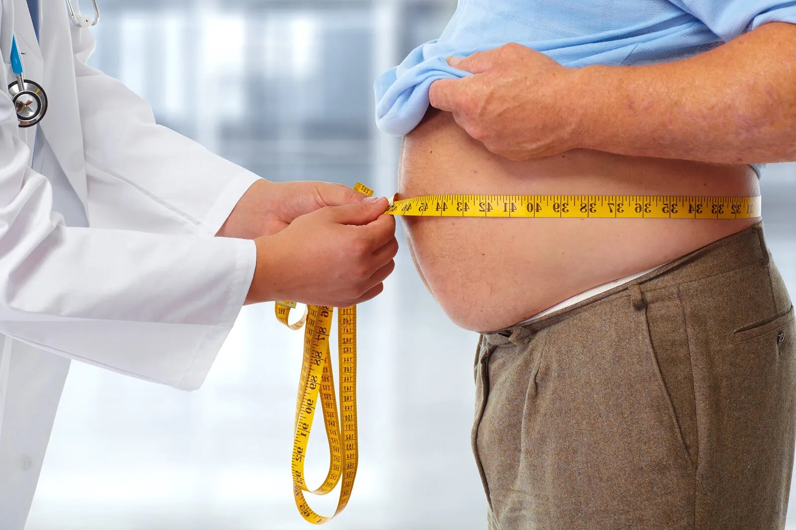 Medical chart comparing waist circumference and BMI thresholds for obesity and metabolic disease risk assessment
