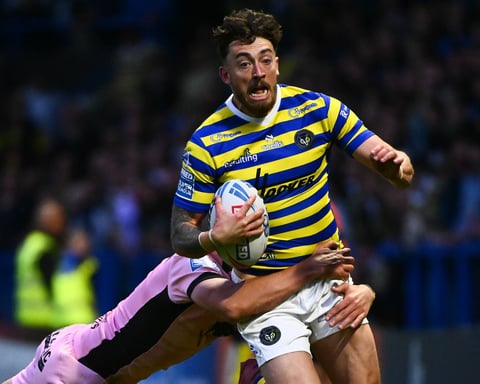 Matty Ashton of Warrington Wolves tackled during Super League Round 13 against Hull FC at Halliwell Jones Stadium