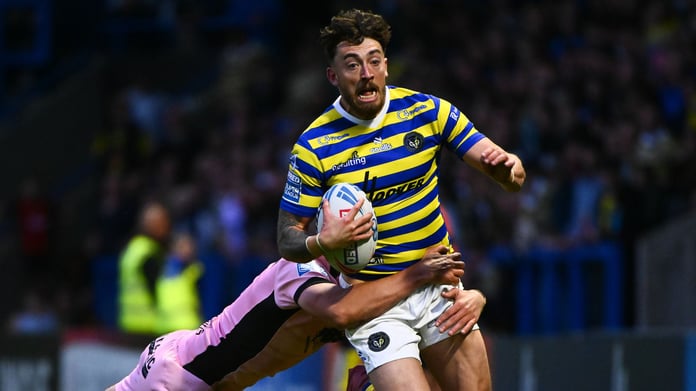 Matty Ashton of Warrington Wolves tackled during Super League Round 13 against Hull FC at Halliwell Jones Stadium