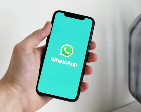 WhatsApp iOS update showing scheduled messages, view once texts, and disappearing chat features on smartphone screen