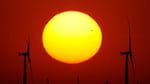 Wind turbines silhouetted at sunset in a field near Cimarron, Kansas, where Pentagon reviews have stalled new wind projects