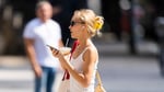 Person wearing wired headphones in urban setting as analog audio revival surges in 2026