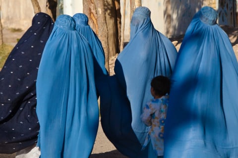 Women in burqas with their children on a street in Herat, Afghanistan, in a file photo