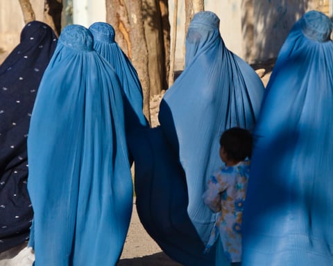 Women in burqas with their children on a street in Herat, Afghanistan, in a file photo