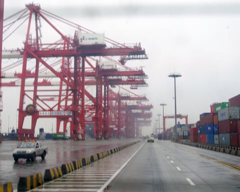 Stacked shipping containers and cranes at Yangshan deep-water port in Shanghai, China