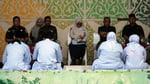 People await public caning in Banda Aceh under Indonesia Aceh Islamic Criminal Code enforcement