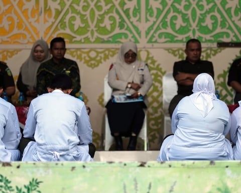 People await public caning in Banda Aceh under Indonesia Aceh Islamic Criminal Code enforcement