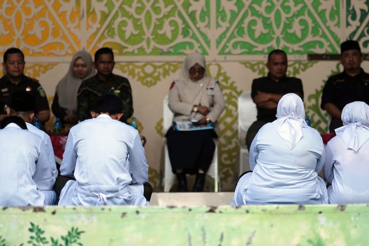 People await public caning in Banda Aceh under Indonesia Aceh Islamic Criminal Code enforcement