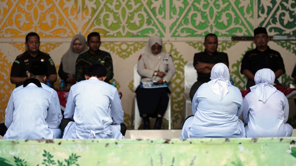 People await public caning in Banda Aceh under Indonesia Aceh Islamic Criminal Code enforcement