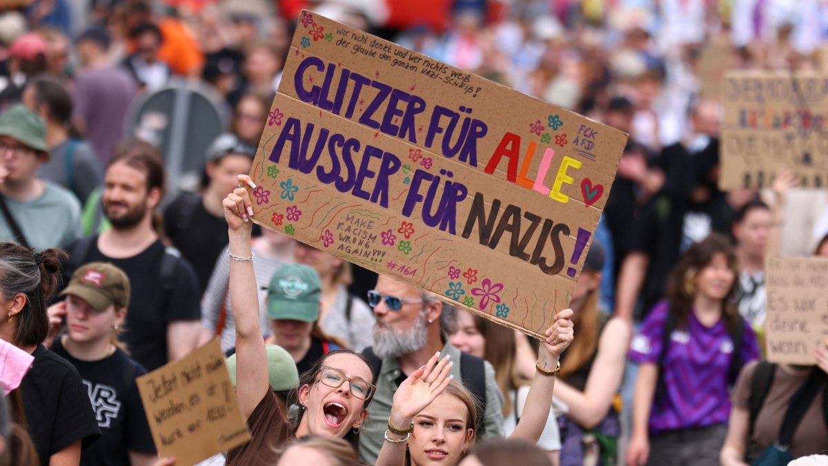 Demonstrators holding signs at anti-AfD protest in Erfurt Germany July 4 2026