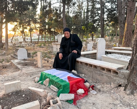 Maarouf Zaid holds a photo of his three-month-old son Ahmad who died at an Israeli checkpoint in the occupied West Bank