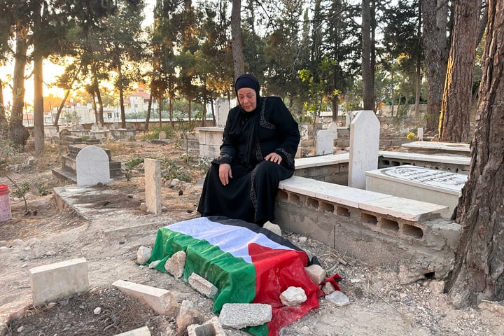 Maarouf Zaid holds a photo of his three-month-old son Ahmad who died at an Israeli checkpoint in the occupied West Bank