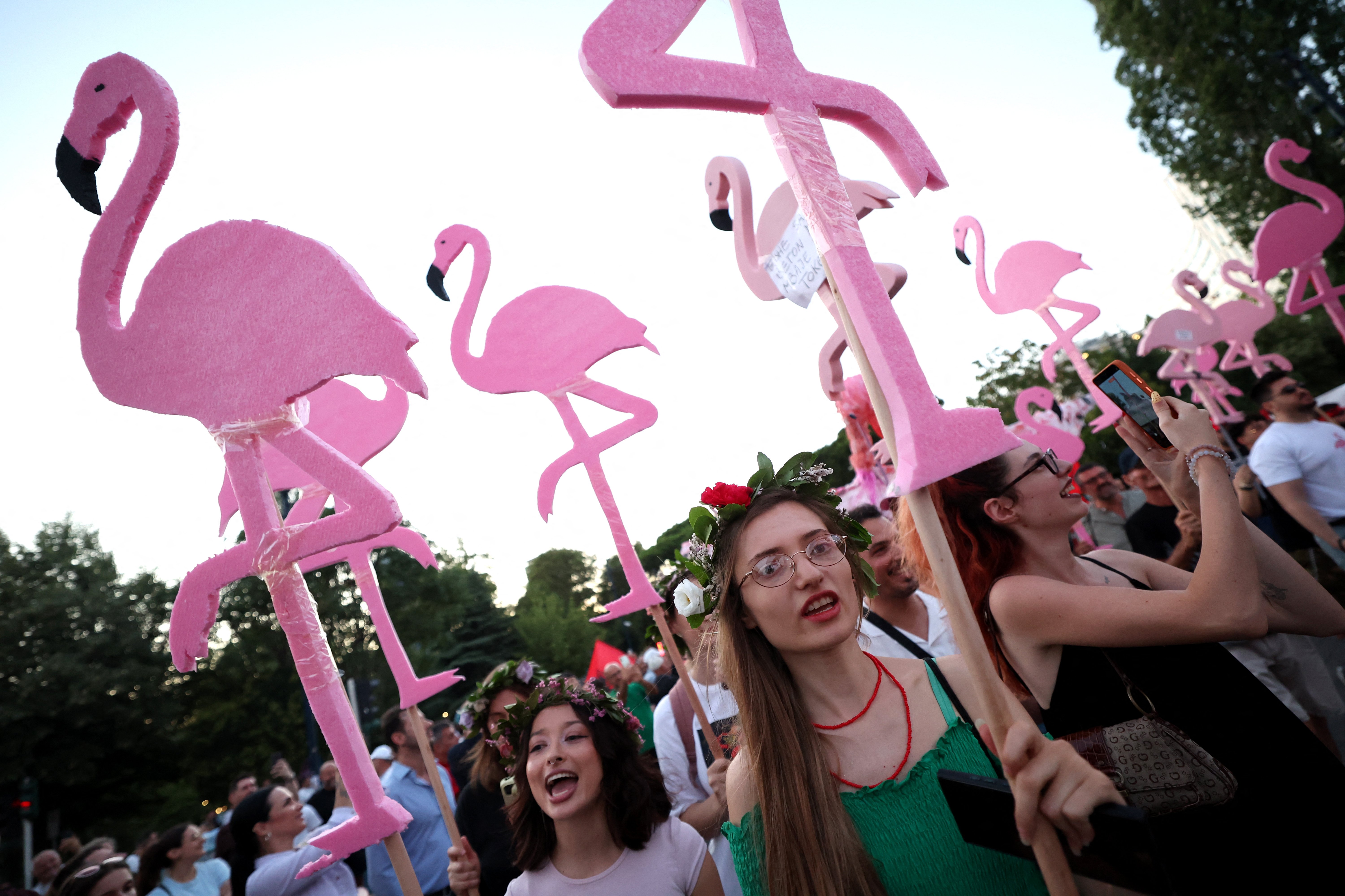 Protesters carrying flamingo signs demonstrate against Jared Kushner's resort project in Tirana Albania July 2026