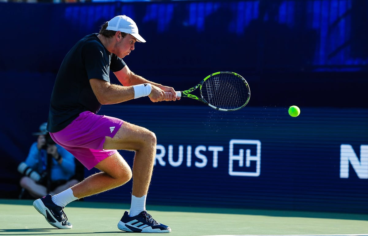 Alex Michelsen hits a backhand during an ATP Tour hard court match