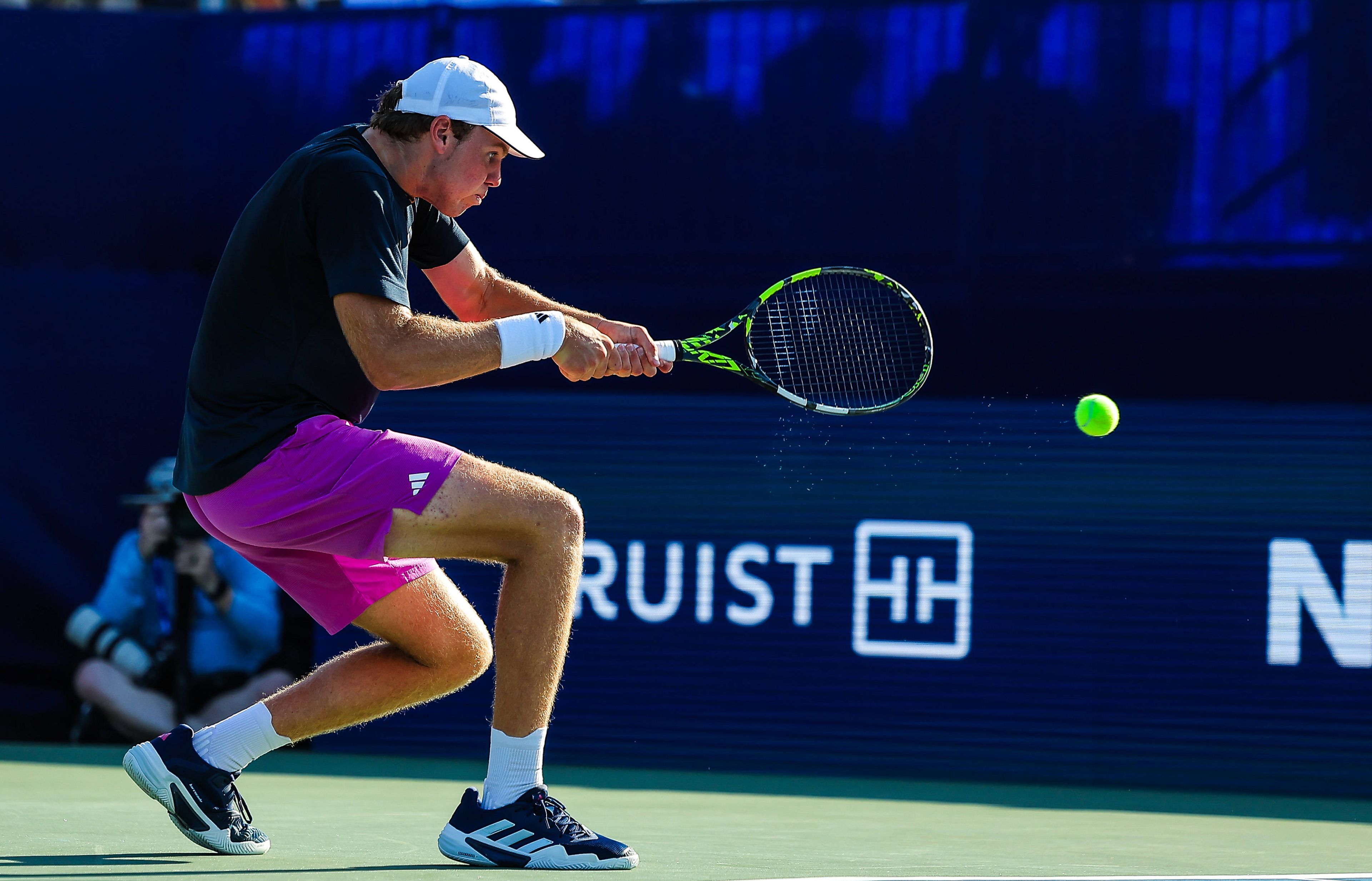 Alex Michelsen hits a backhand during an ATP Tour hard court match