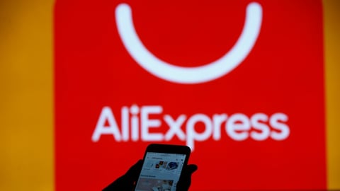 AliExpress logo displayed on a smartphone screen against EU flag background
