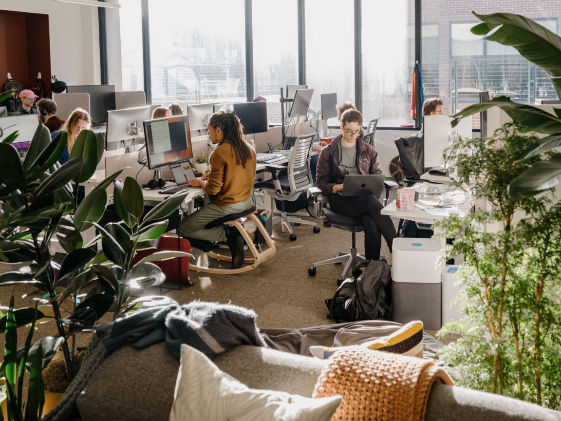 Anthropic team members working in open sunlit office, the AI company whose stake anchors Situational Awareness fund's remaining portfolio