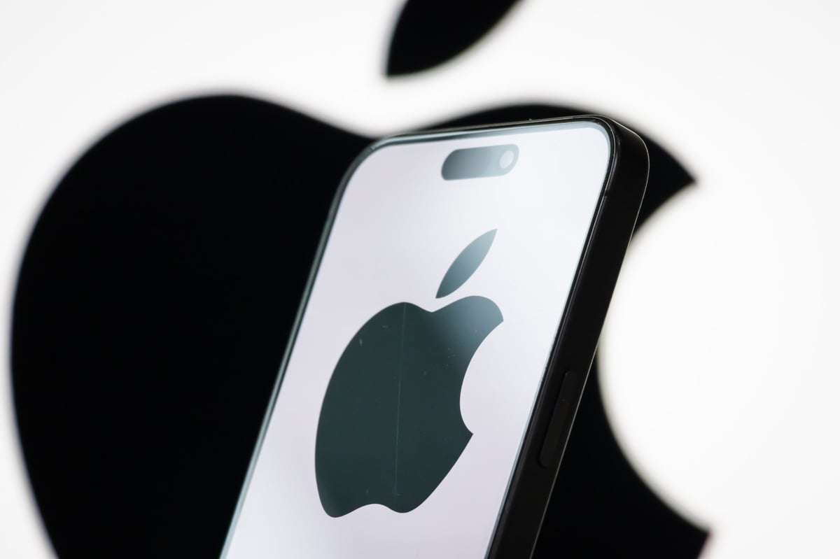 Photo illustration of the Apple logo displayed on a smartphone screen