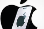 Photo illustration of the Apple logo displayed on a smartphone screen