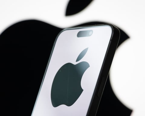 Photo illustration of the Apple logo displayed on a smartphone screen