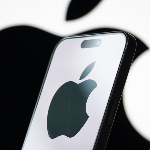 Photo illustration of the Apple logo displayed on a smartphone screen
