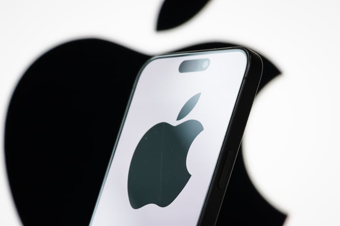 Photo illustration of the Apple logo displayed on a smartphone screen