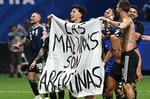 Lisandro Martinez and Giovani Lo Celso hold Falklands sovereignty banner after Argentina beat England at 2026 World Cup