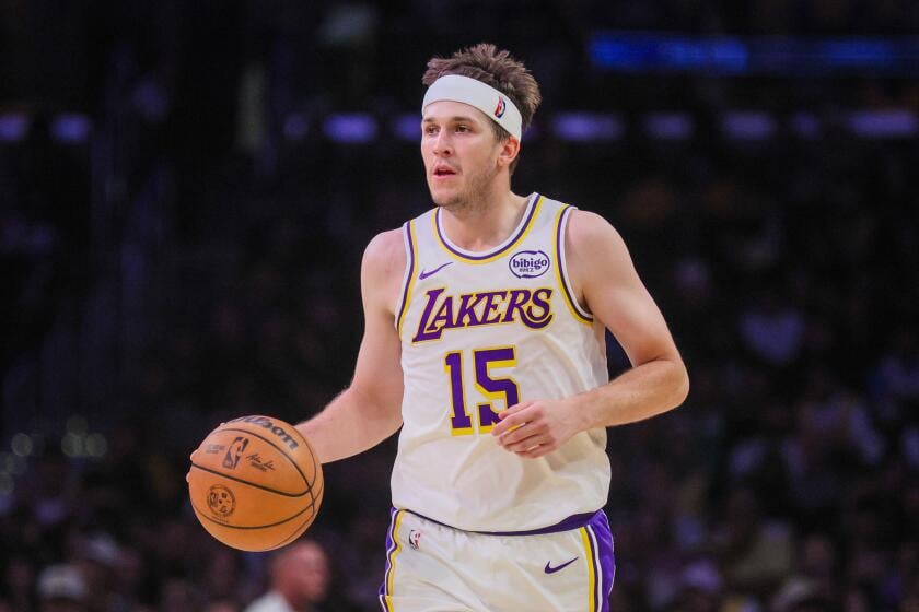 Austin Reaves number 15 dribbles for the Los Angeles Lakers against the Sacramento Kings