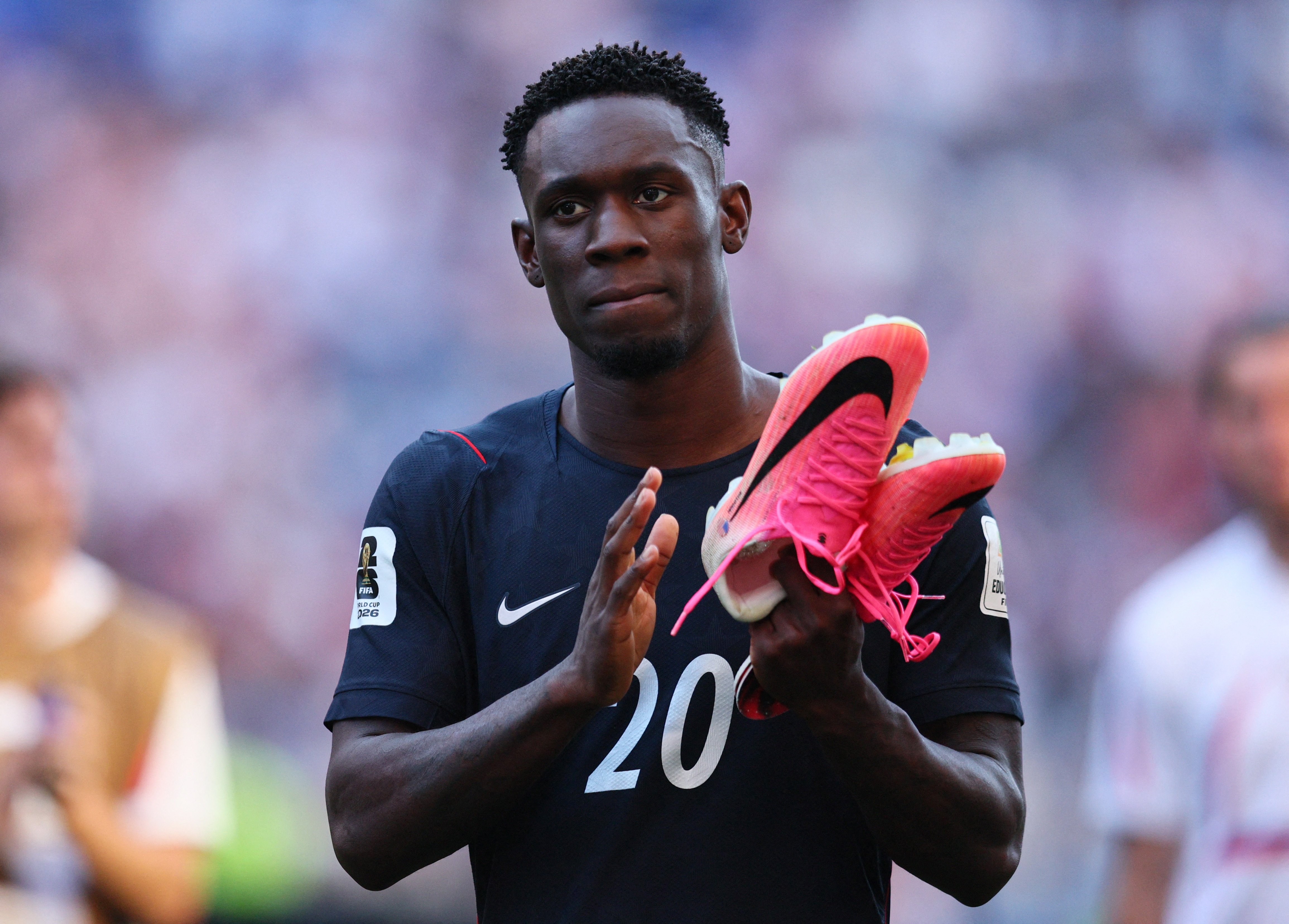 Folarin Balogun applauds fans after Belgium defeated the United States 4-1 in the 2026 World Cup last 16, a match he played after FIFA reversed his automatic red-card ban
