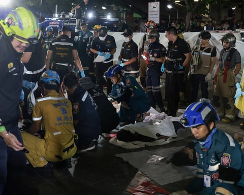 Emergency personnel and firefighters at the scene of the Na Ladprao pub fire in Bangkok that killed 27 people on July 13 2026