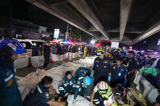 Rescue workers carry a victim from the Na Ladprao pub fire in Bangkok Thailand July 2026