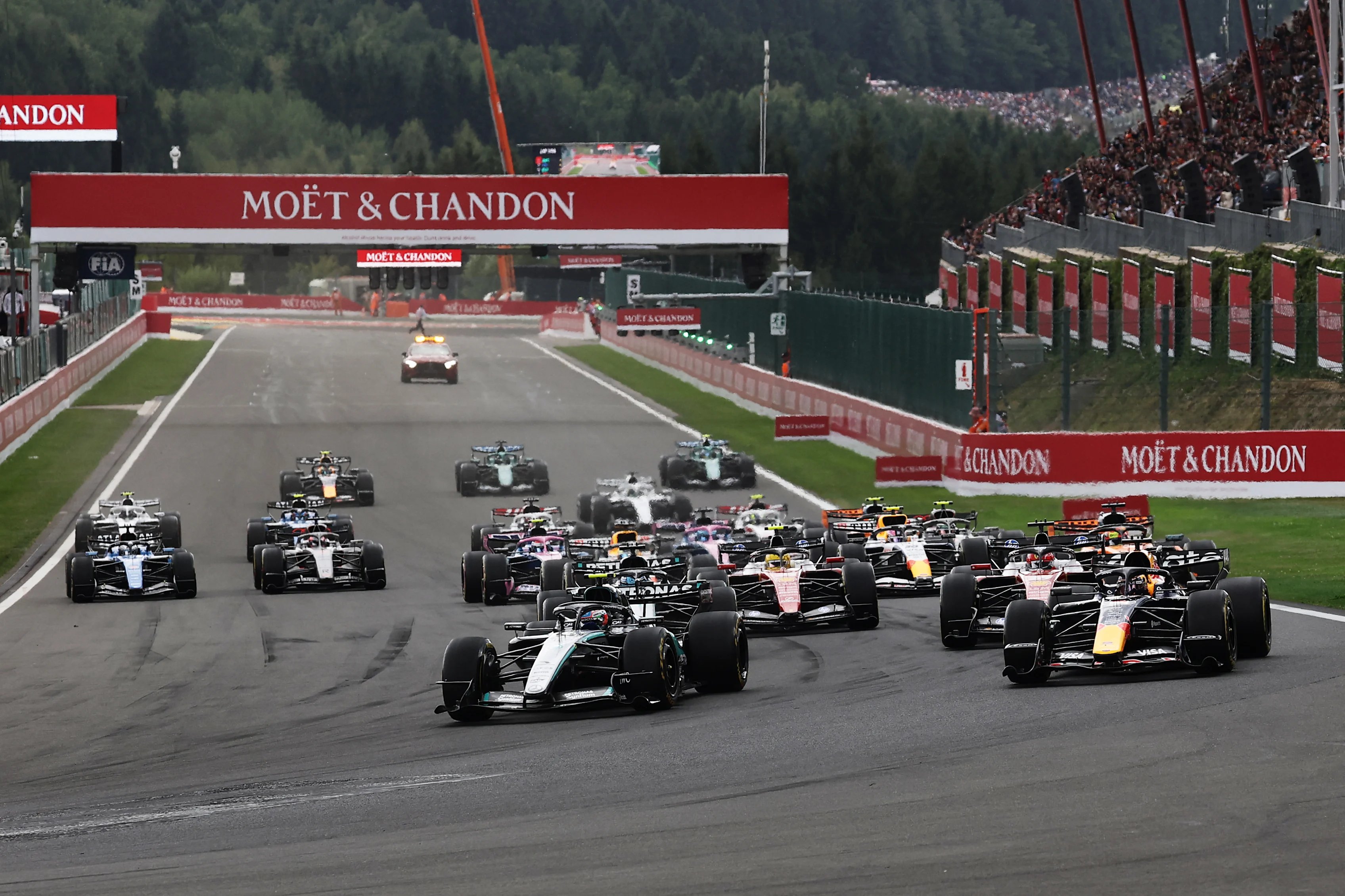 Race action from the 2026 Belgian Grand Prix at Spa-Francorchamps showing the moment of the Hamilton-Russell collision