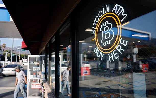 A sign advertising a Bitcoin ATM at a gas station in Pasadena, California