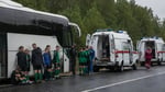 Belarusian youth football team players stand beside their bus with emergency services after drone strike in Bryansk region Russia June 2026
