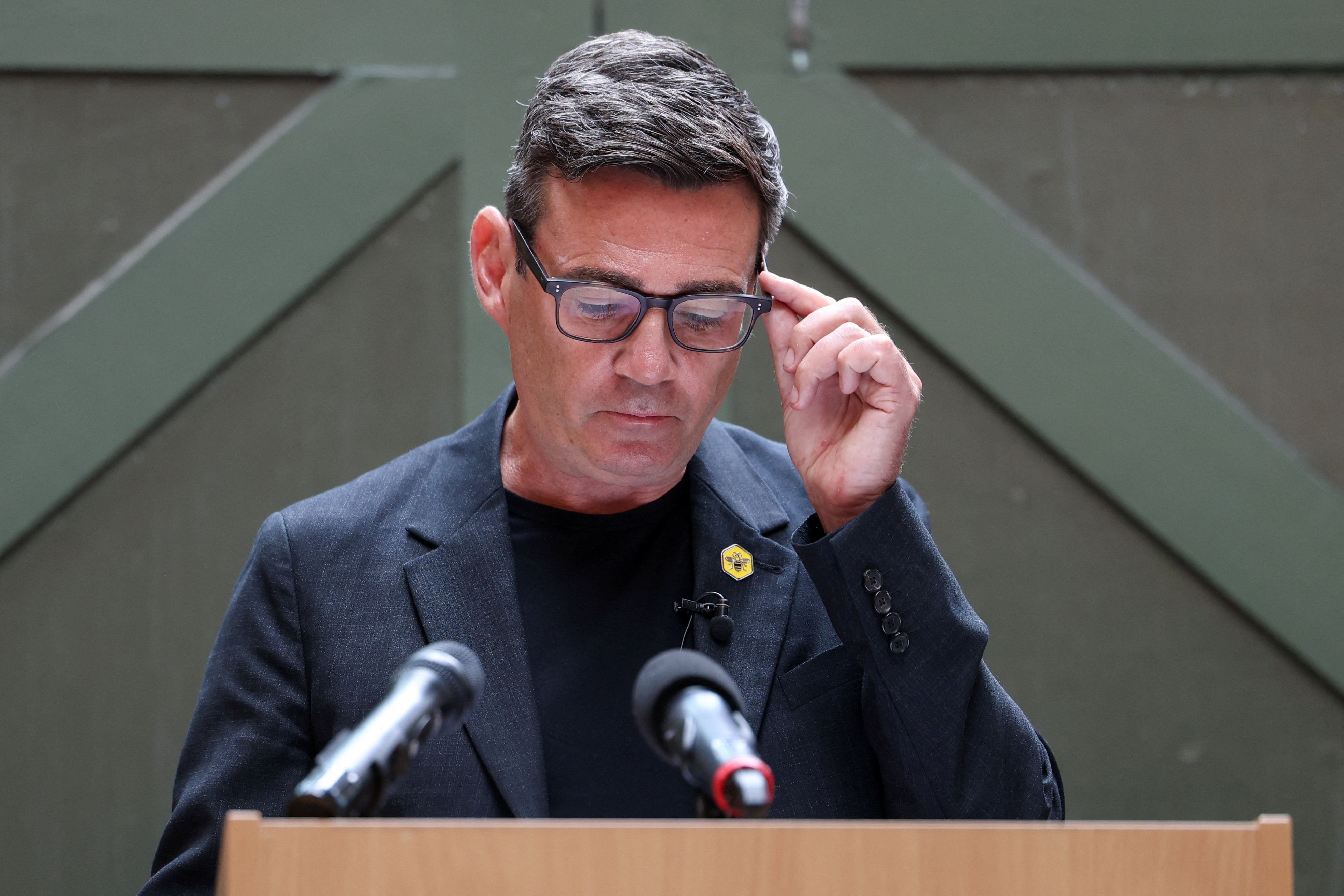Andy Burnham speaks at a podium as UK incoming prime minister apologises for Labour Gaza response