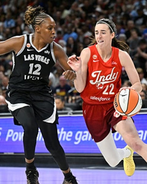 Caitlin Clark dribbling for Indiana Fever setting WNBA assist record