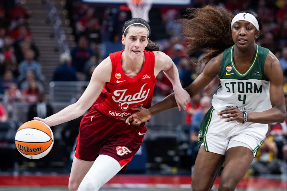 Caitlin Clark driving against Seattle Storm guard Flau’jae Johnson at Gainbridge Fieldhouse