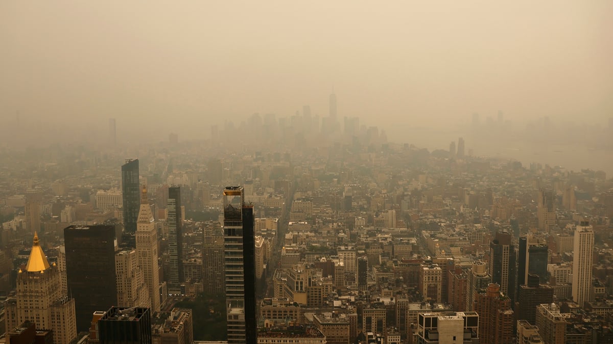 Wildfire smoke from Canadian wildfires creates orange haze over New York City skyline