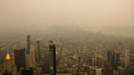 Wildfire smoke from Canadian wildfires creates orange haze over New York City skyline