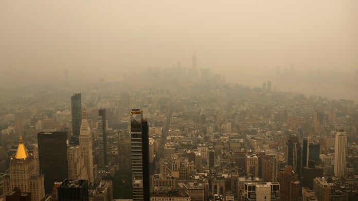 Wildfire smoke from Canadian wildfires creates orange haze over New York City skyline